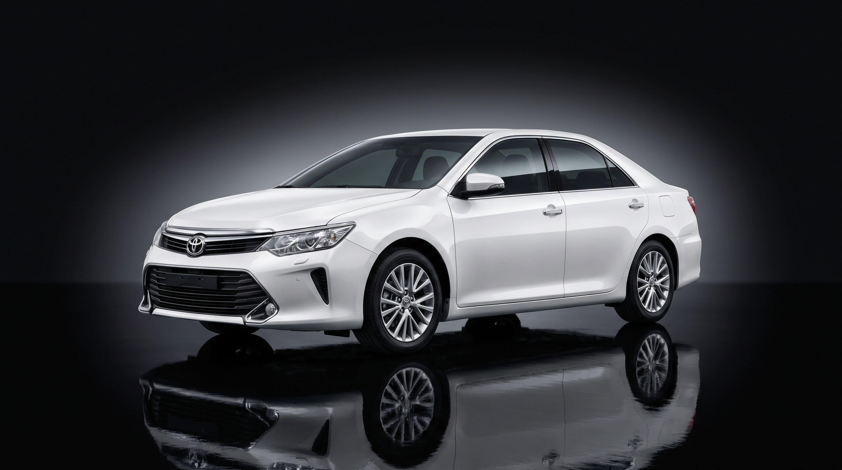 White Toyota Camry sedan in studio
